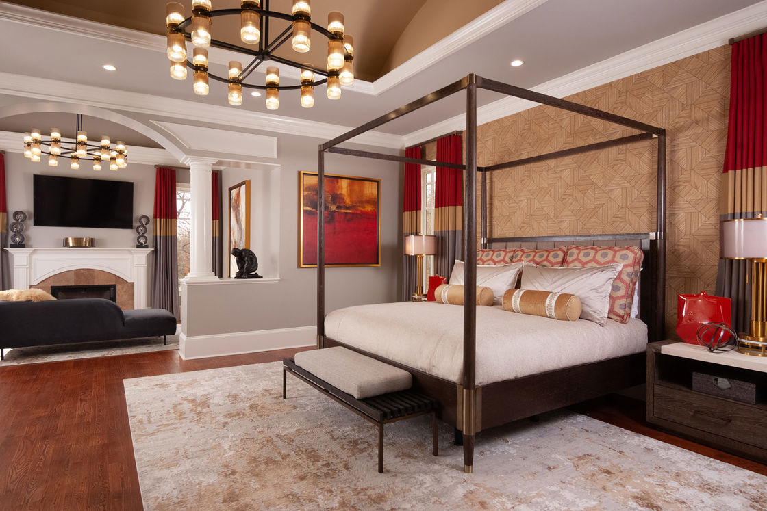 Bedroom with circular chandelier, steel bed frame and wooden floors