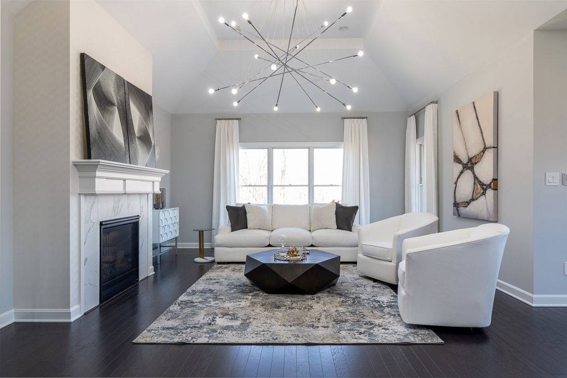 Living room with hanging pendant lamps and white furnishings