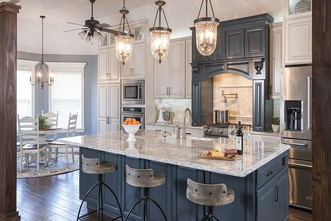 Kitchen with bell jar pendant lights, marble granite countertop and blue and white accents