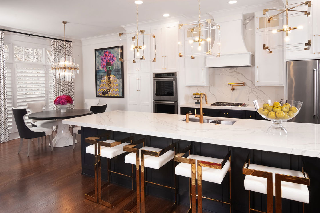 Kitchen with white granite countertop and gold and white chairs