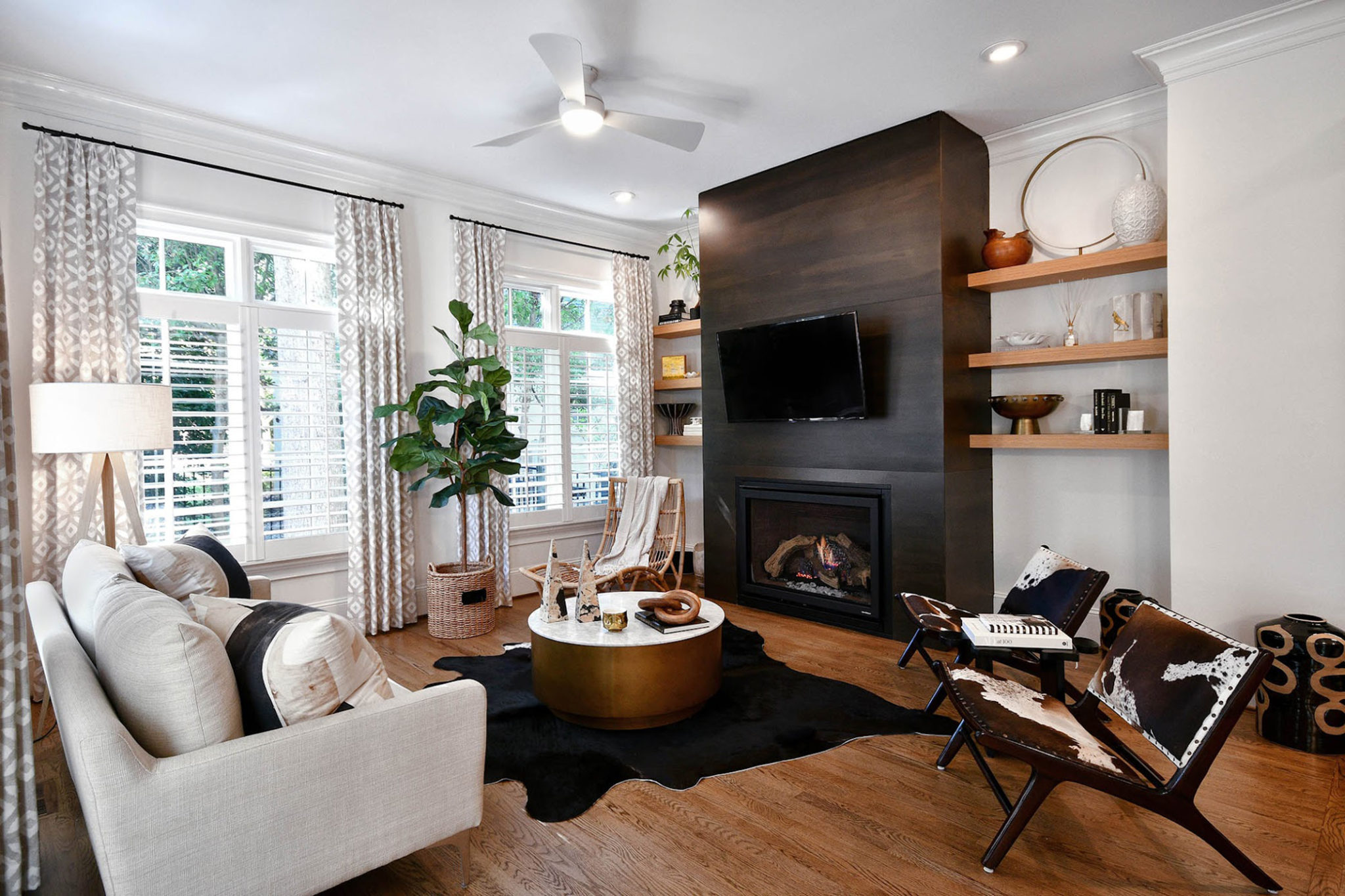 A living room with couch, center table, chair, and television