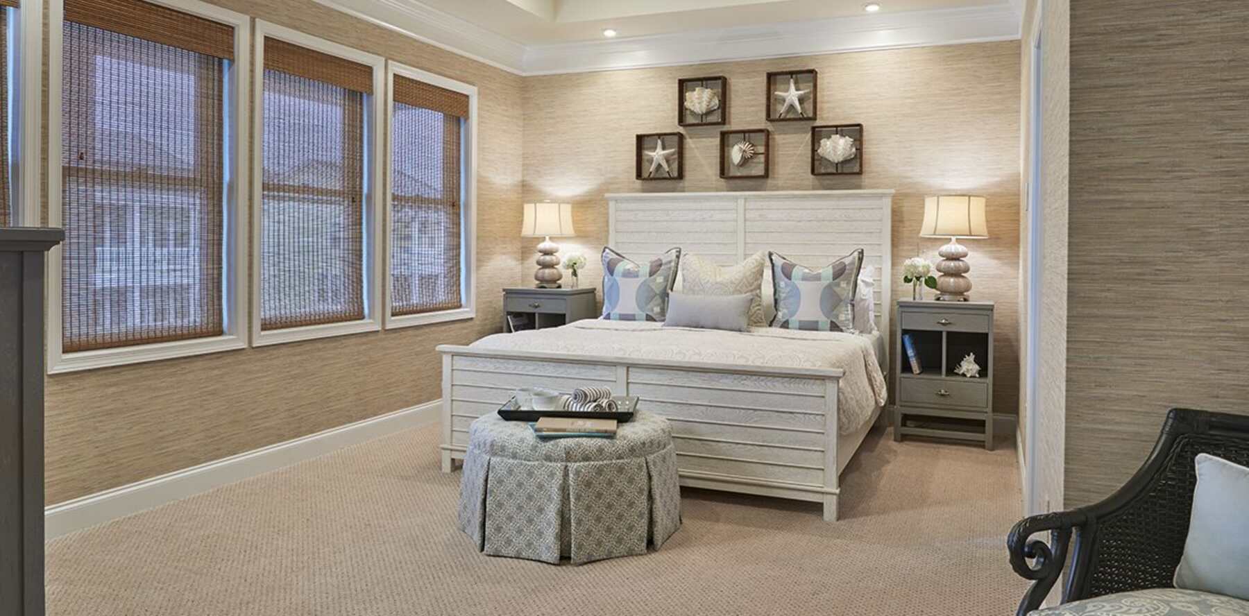 Bedroom with a full nude carpet and coastal silver accents