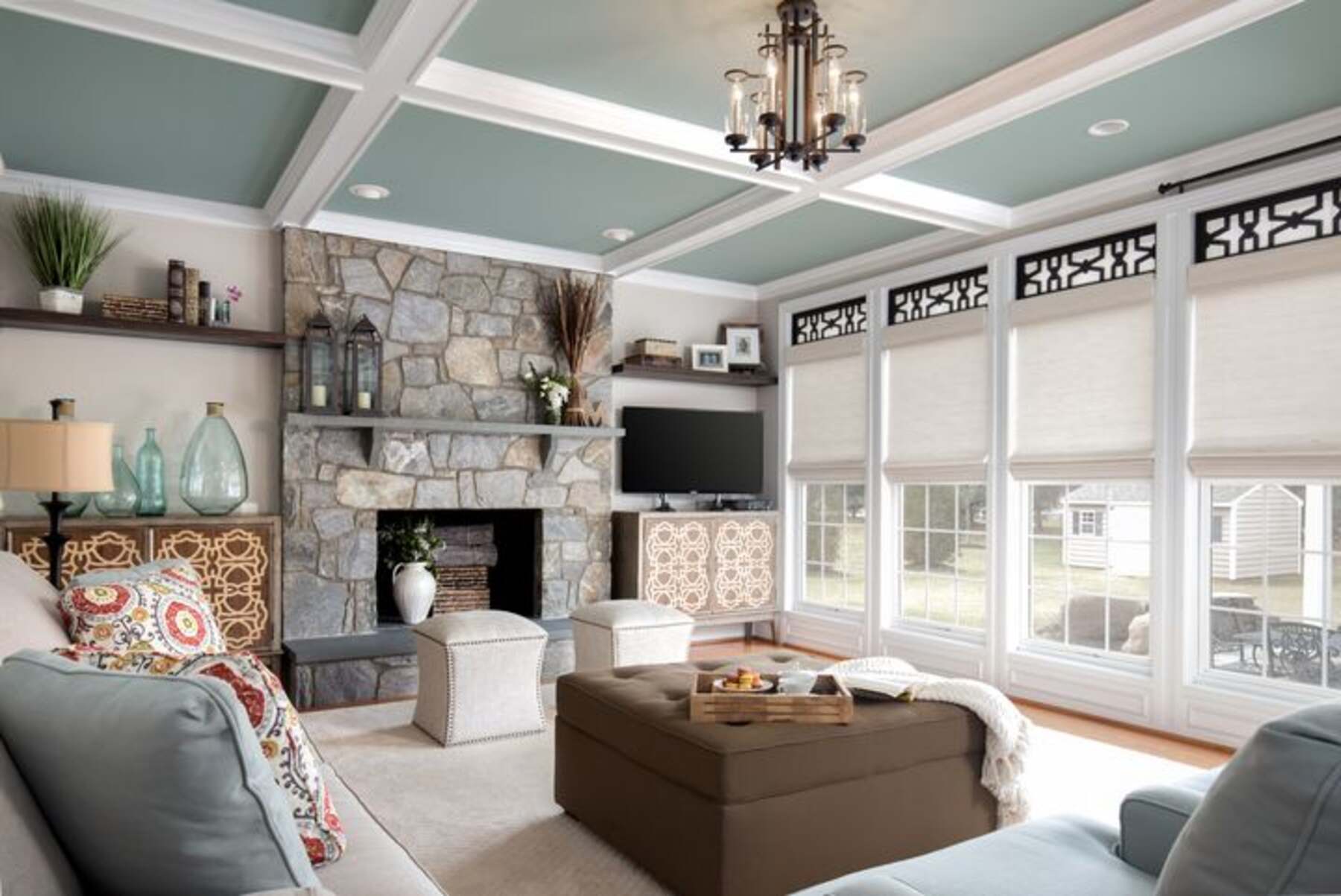 Living room with white and gray couch and tall glass windows
