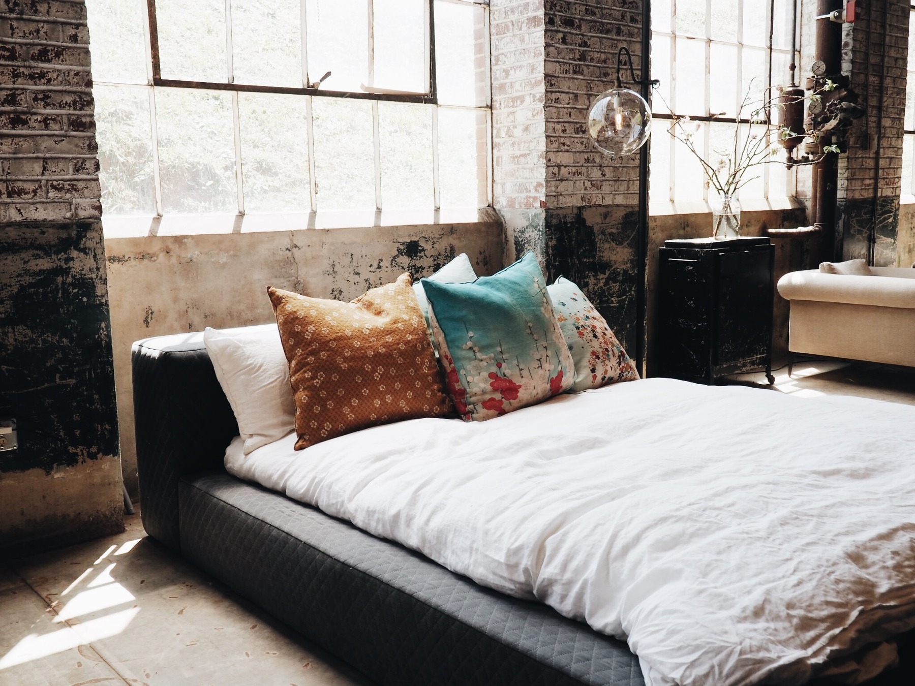 A bedroom with pillows and sheets