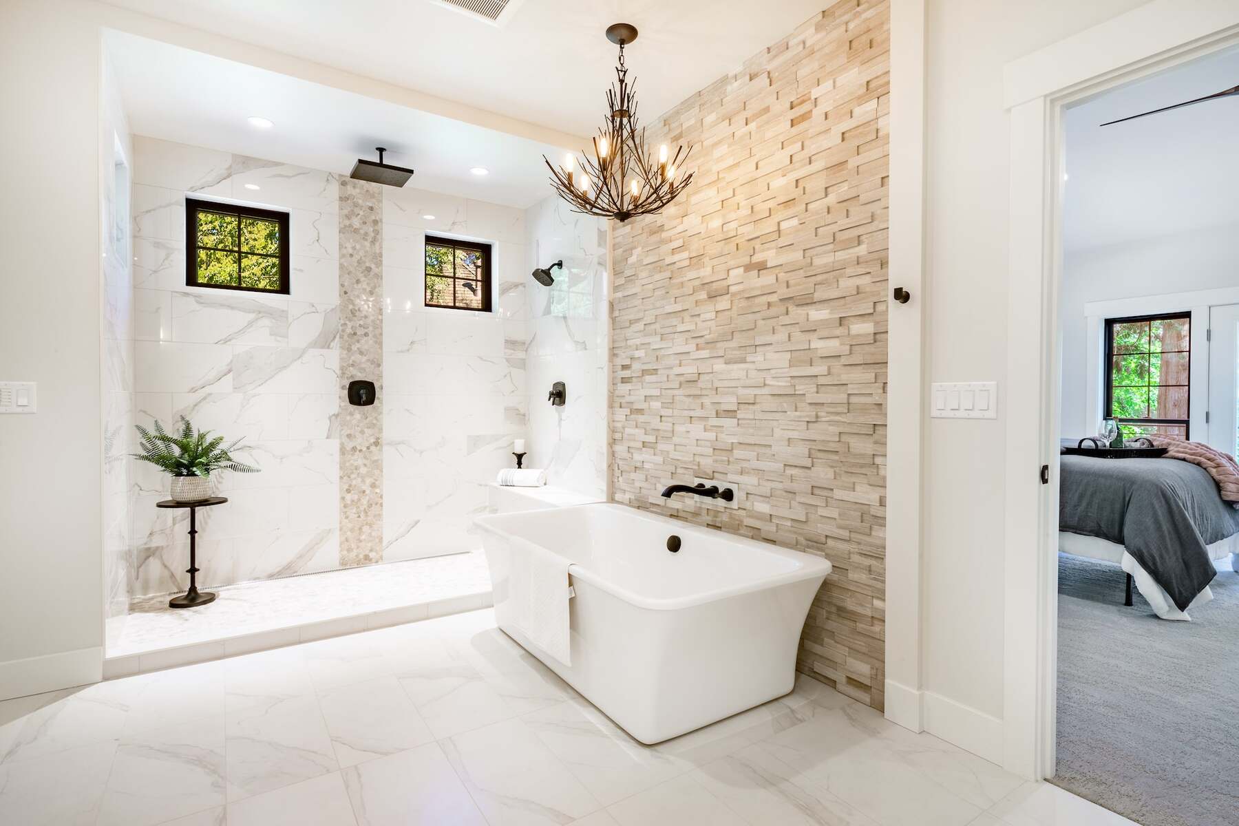 Bathtub placed against a tiled wall on an expansive bathroom
