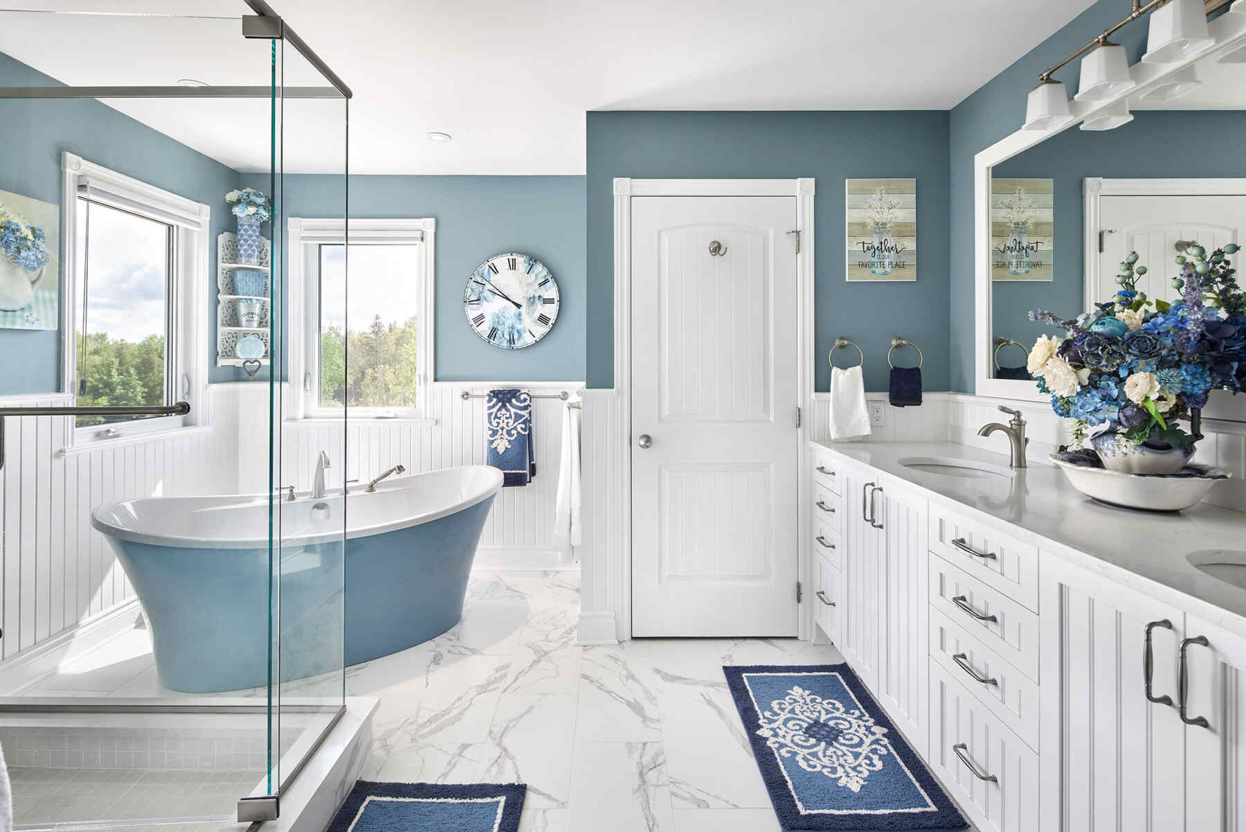 Bathroom with blue accents and clear glass shower door