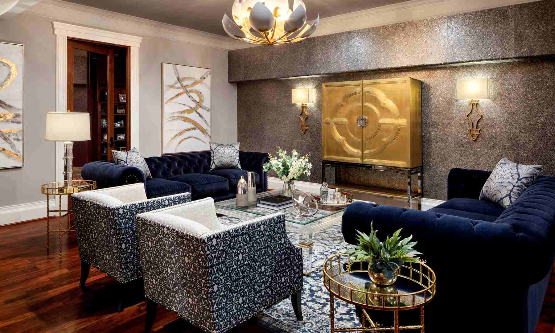 Living room with blue tufted sofas and two armchairs with aesthetic hanging light fixture