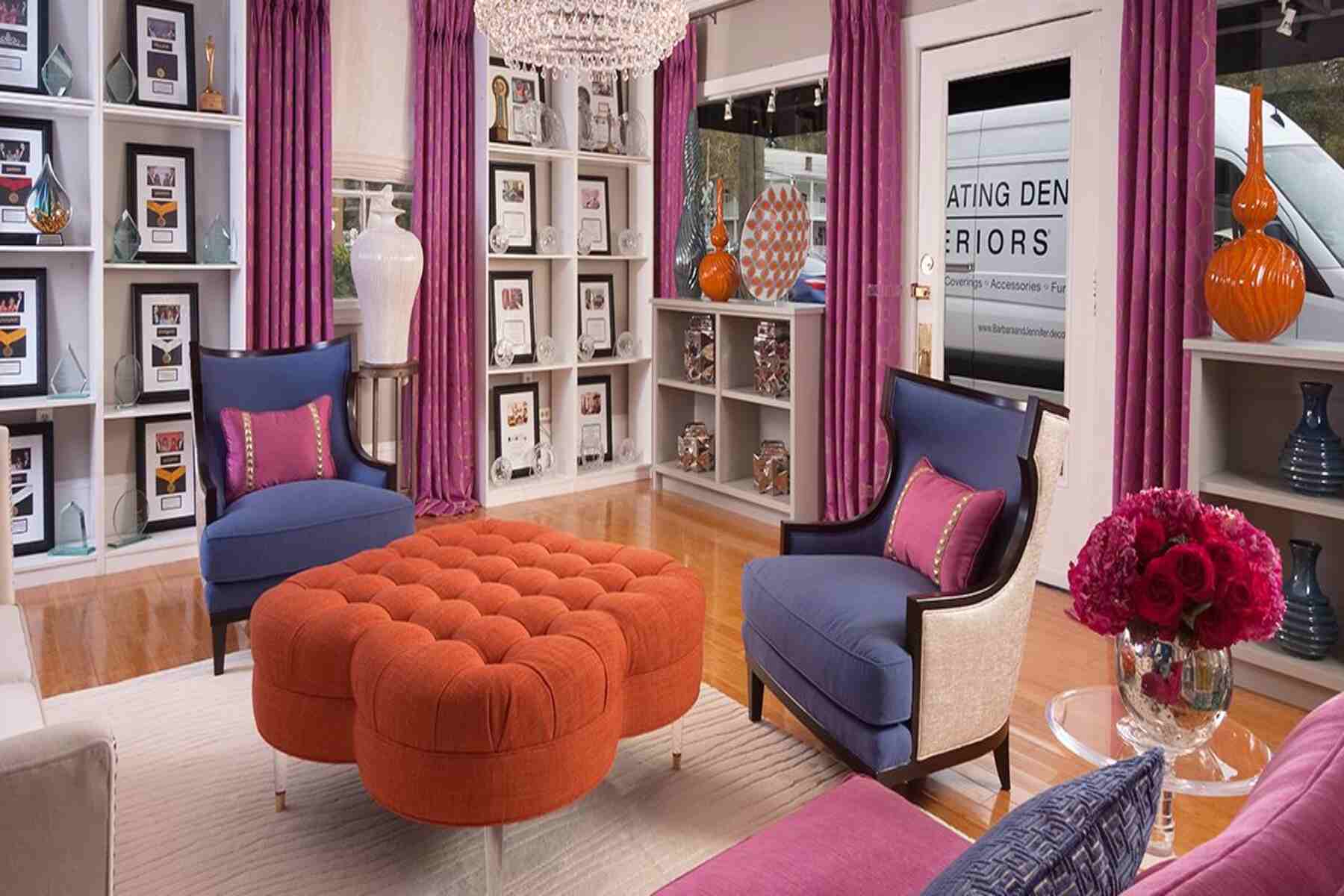 A room with bold colored chairs and curtains