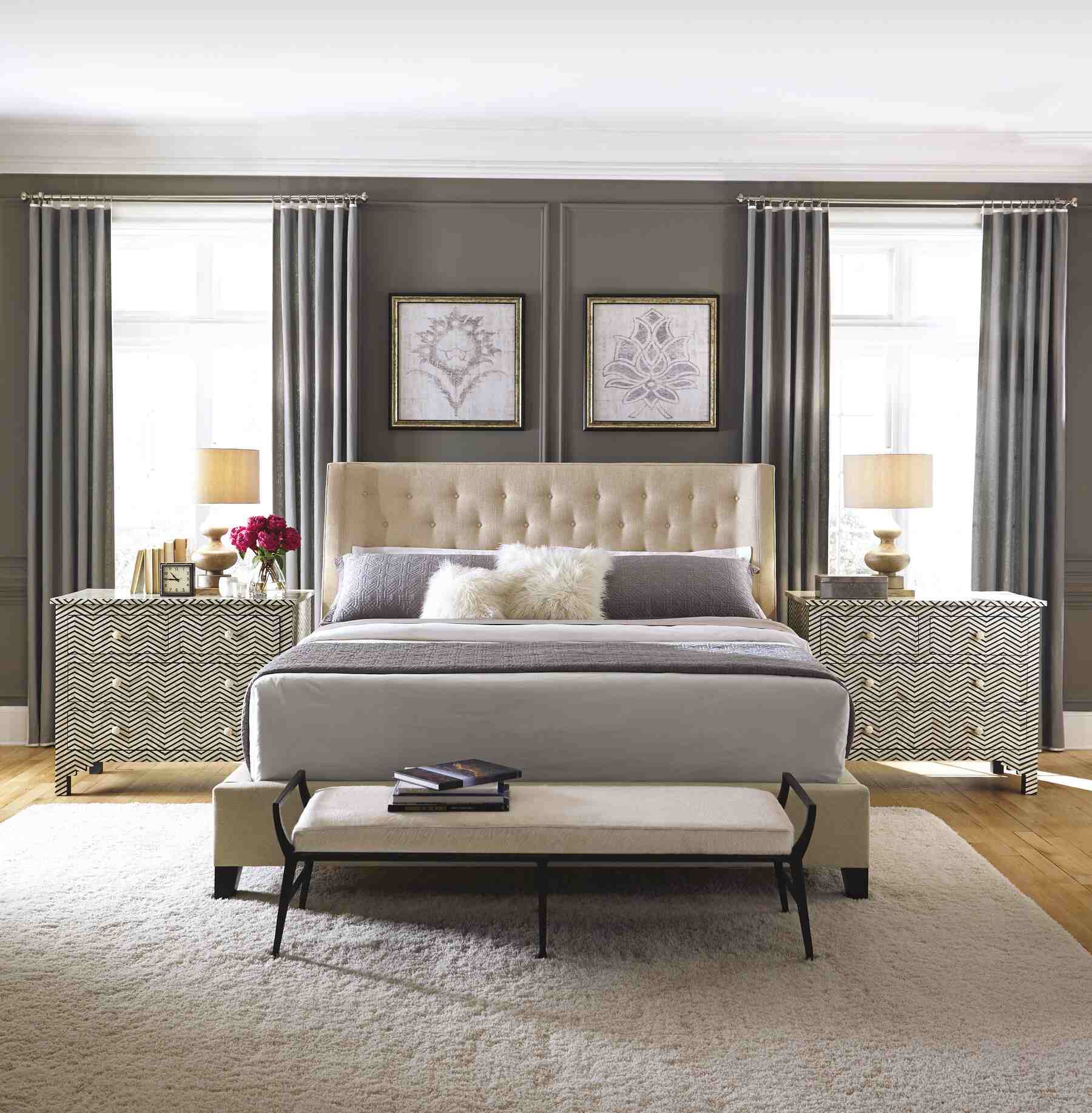 A cozy bedroom with a comfortable bed, stylish dressers, and elegant nightstands