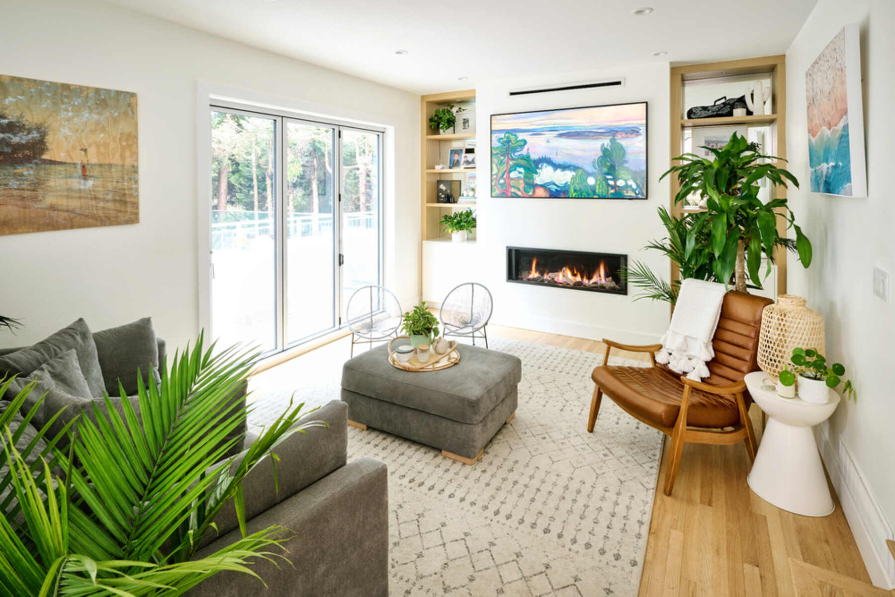 A cozy living room with a fireplace, a comfortable couch, and vibrant plants adding a touch of nature