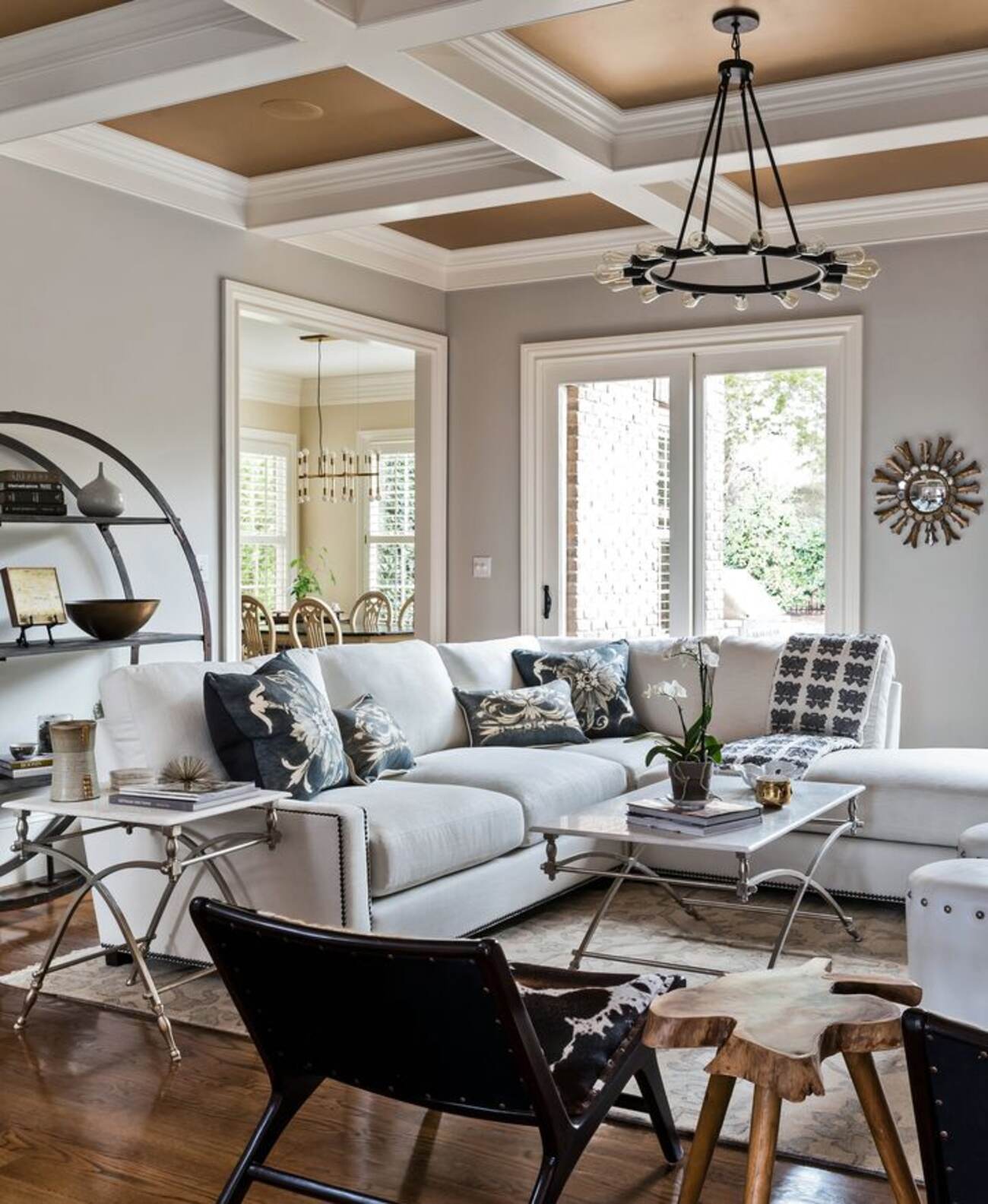 A chic living room with elegant white furniture and a stunning chandelier hanging from the ceiling