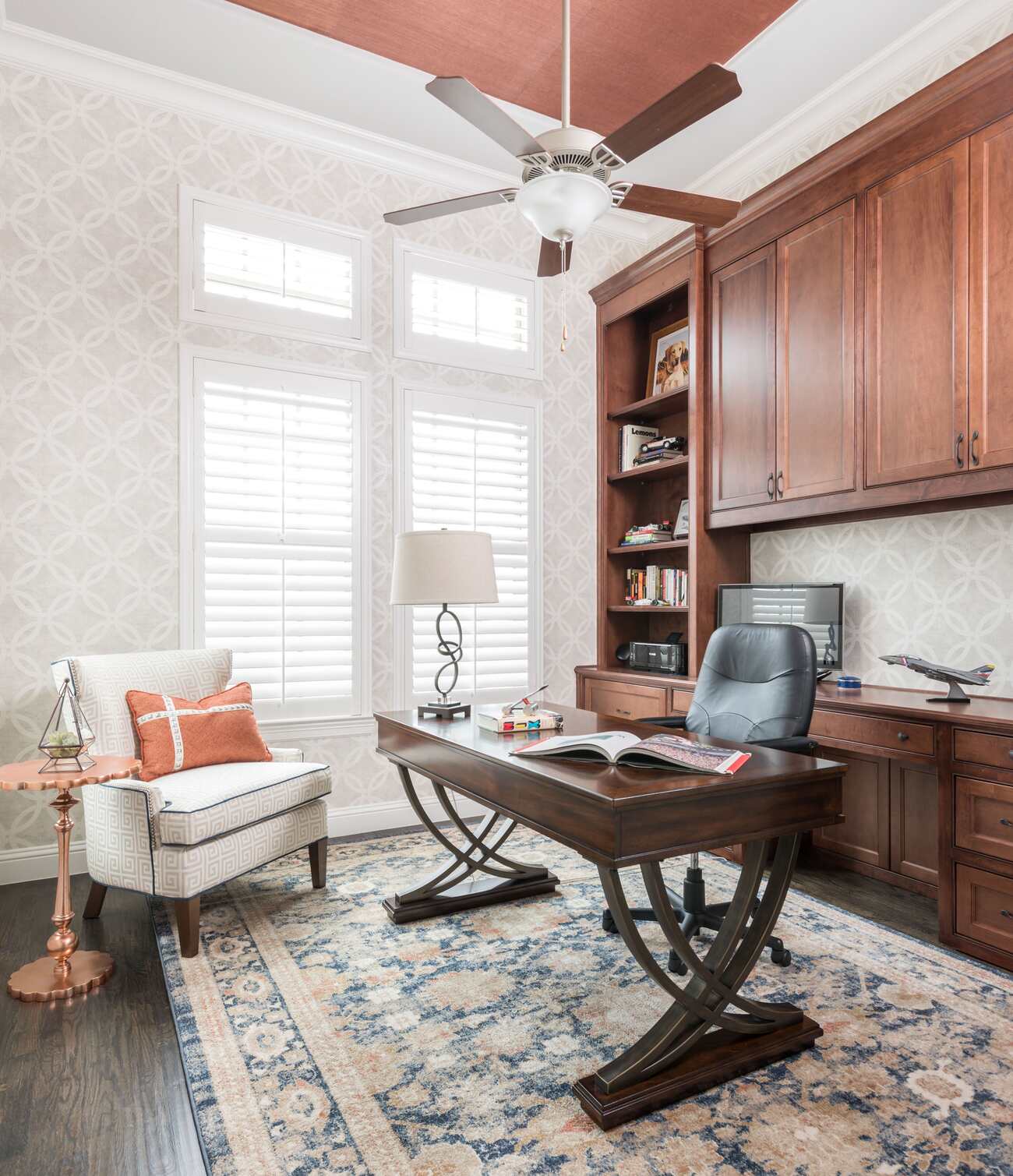 A cozy home office with a stylish desk and a ceiling fan, creating a comfortable and productive workspace