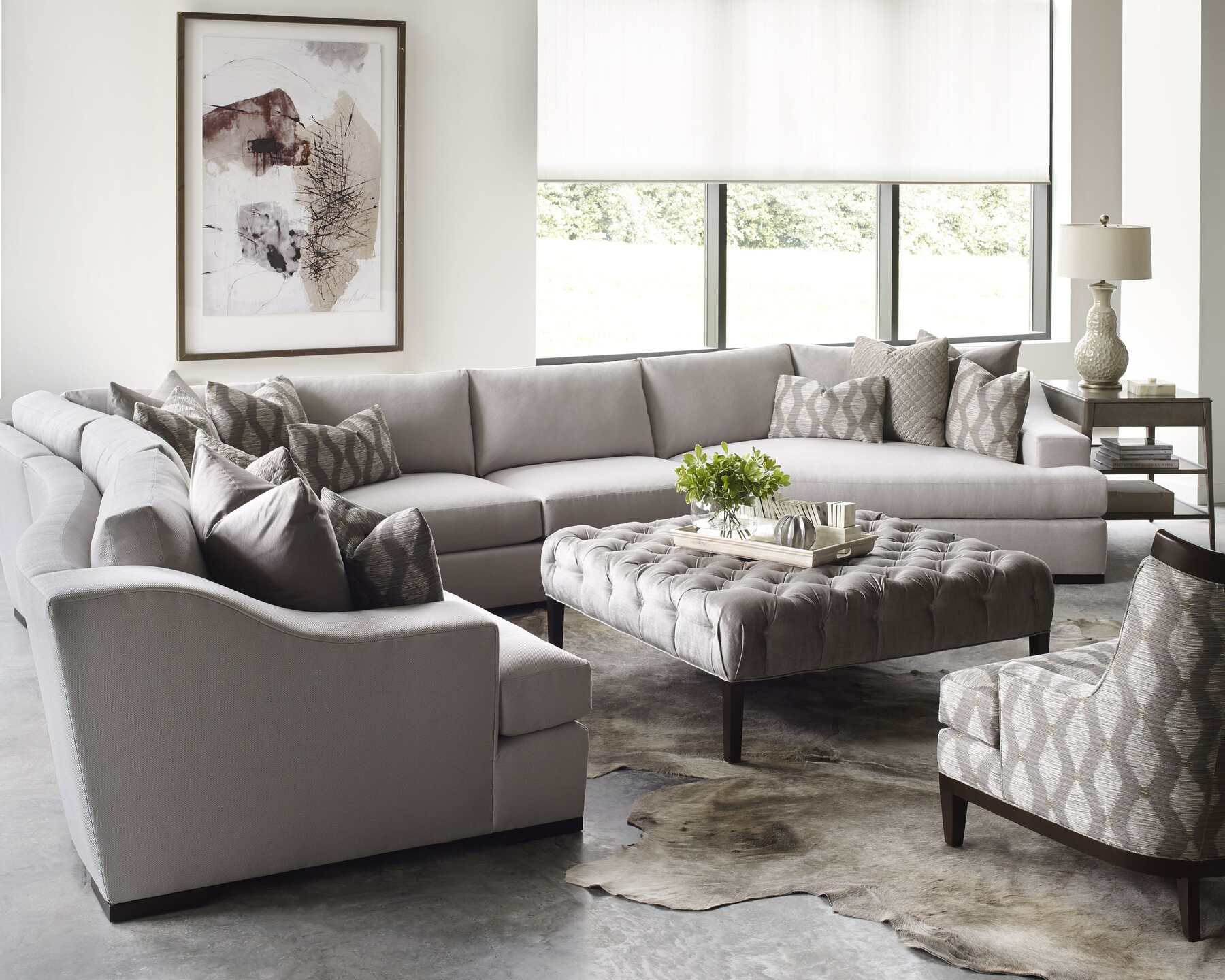 Interior of a living room featuring a sectional couch and ottoman