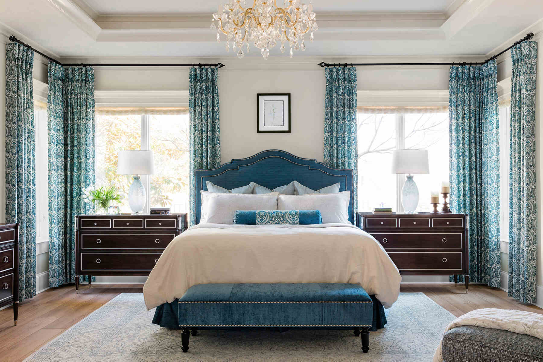 A cozy bedroom with a soothing blue and white color scheme